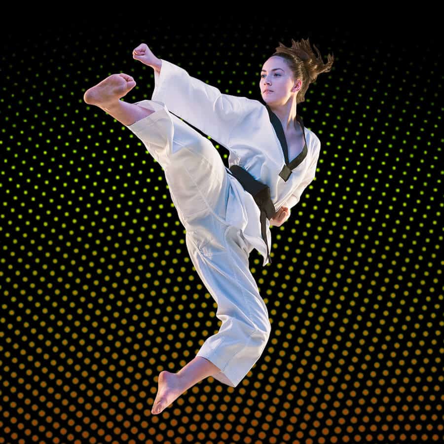 Martial Arts Lessons for Adults in Huntington Station NY - Girl Black Belt Jumping High Kick