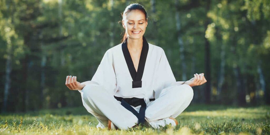 Martial Arts Lessons for Adults in Huntington Station NY - Happy Woman Meditated Sitting Background