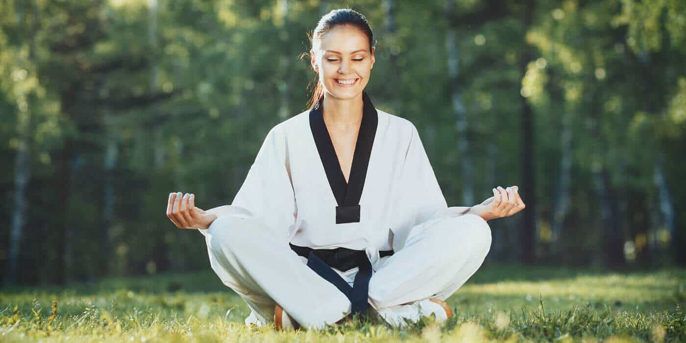 Martial Arts Lessons for Adults in Huntington Station NY - Happy Woman Meditated Sitting Background